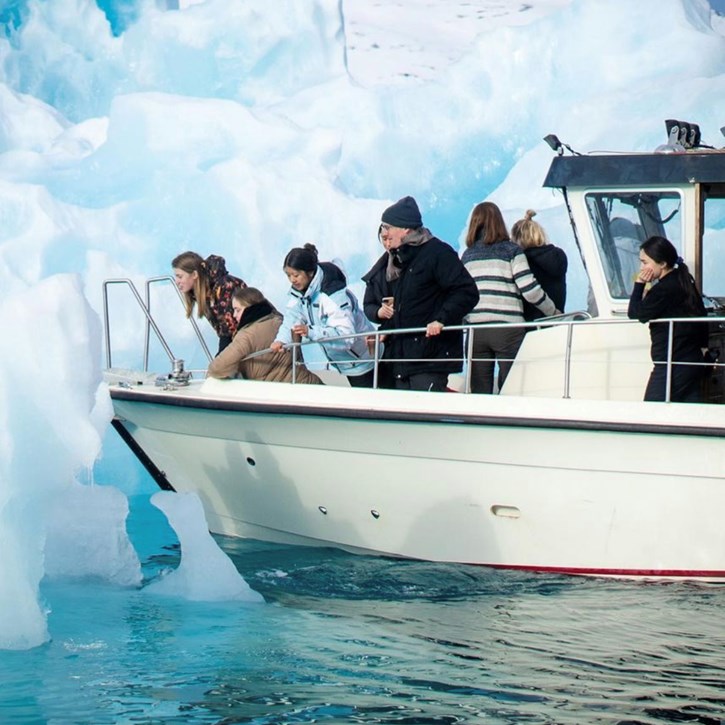 Elever og medarbejder på båd i havet ved Nuuk